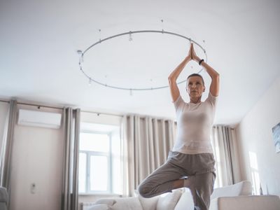 Person moving gracefully between two yoga poses, showing a fluid motion.